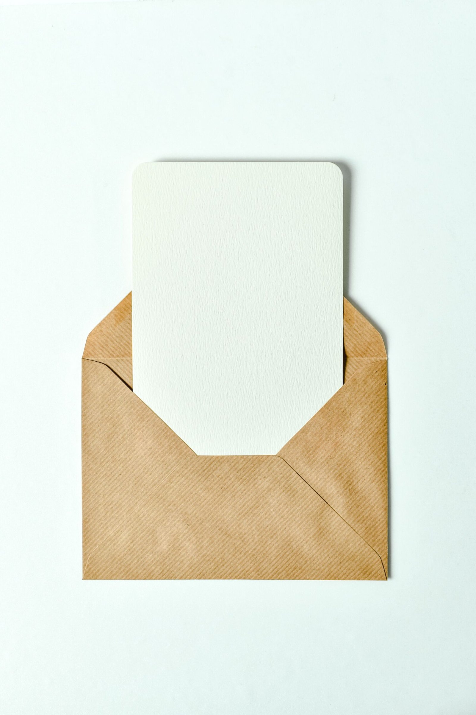 Minimalist brown envelope showcasing a blank card insert - perfect for invitations or greetings.